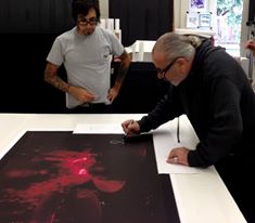 Avi Dosaj of Scene Four with Bill Ward signing an art piece.